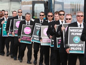 About 150 WestJet pilots protested outside the company's headquarters in Calgary during the WestJet annual general meeting on Tuesday.