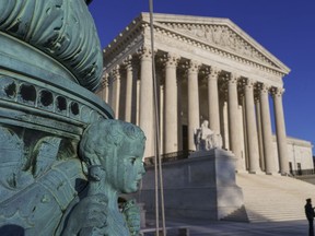 The Supreme Court is seen in Washington, April 20, 2018.  The Supreme Court says employers can prohibit their workers from banding together to complain about pay and conditions in the workplace.