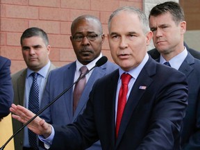 CORRECTS THE POSITION OF PERROTTA TO LEFT, NOT SECOND LEFT - FILE - In this April 19, 2017, file photo, Environmental Protection Agency Administrator Scott Pruitt speaks at a news conference with Pasquale "Nino" Perrotta, left, in East Chicago, Ind. Pruitt is announcing the departure of two top aides amid ethics investigations at the agency. Pruitt says his security chief, Pasquale "Nino" Perrotta, was retiring. He gave no cause, but Pruitt's spending on security at the EPA is the subject of ongoing federal investigations. Pruitt also announced the departure of Albert Kelly, a former Oklahoma banker in charge of the toxic waste cleanups.