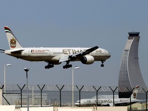 FILE - In this May 4, 2014 file photo, an Etihad Airways plane prepares to land at the Abu Dhabi airport in the United Arab Emirates. The United States and the United Arab Emirates have signed a deal resolving a years-old spat over alleged Emirati government subsidies to its airlines and accusations of unfair competition in the U.S. The deal was signed Friday in private at the State Department after months of negotiations.