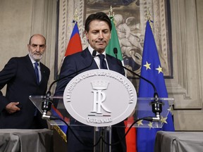 Italian Premier-Designate Giuseppe Conte addresses the media after meeting Italian President Sergio Mattarella in Rome, Sunday, May 27, 2018. Conte relinquished a presidential mandate to put together an acceptable Cabinet.
