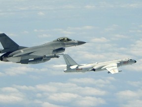 In this May 11, 2018 photo released by Taiwan's Ministry of National Defense, a Taiwanese Air Force fighter aircraft, left, flies near a Chinese People's Liberation Army Air Force (PLAAF) H6-K bomber that reportedly flew over the Luzon Strait south of Taiwan during an exercise. Taiwan is seeking to build-up its domestic defense industry in the face of China's threats and the reluctance of foreign arms suppliers to provide it with planes, ships, submarines and other hardware to defend its 23 million people. (Ministry of National Defense via AP)