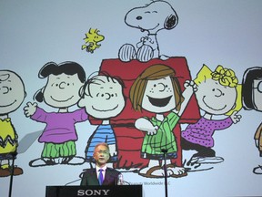 Sony Corp. President Kenichiro Yoshida speaks as characters from Peanuts are shown at a press conference at the company's headquarters Tuesday, May 22, 2018, in Tokyo. Electronics and entertainment company Sony Corp. is investing 1 trillion yen ($9 billion) mostly in image sensors over the next three years. Sony Corp. said last week that it is buying a stake in Peanuts Holdings, the company behind Snoopy and Charlie Brown.