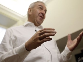 Marco Zambelli wears his prosthetic hand during an interview with the Associated Press in Rome Thursday, May 10, 2018. An Italian government-funded research institute and prosthetic maker unveiled a new robotic hand that they say amputees to grip objects with more precision, and with a mechanical design that will significantly bring down the price of a myoeletric prosthetic hand.