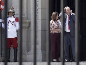 FILE - In this March 21, 2018 file photo, Peru's President Pedro Pablo Kuczynski talks on his cellphone as he vacates the House of Pizarro, the presidential residence and workplace, in Lima, Peru. Kuczynski resigned amid allegations that the Brazilian construction giant Odebrecht paid his consulting firm $780,000 a decade ago. Kuczynski denies wrongdoing.