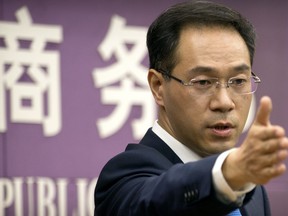 In this March 29, 2018 photo, Chinese Ministry of Commerce spokesman Gao Feng speaks during a press conference at the Ministry of Commerce in Beijing. China has criticized proposed U.S. investment controls on Thursday, May 31, 2018, as a violation of global trade rules and says it reserves the right to retaliate if they take effect.