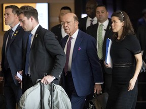 U.S. Commerce Secretary Wilbur Ross, center, leaves his hotel in Beijing, Friday, May 4, 2018. Chinese and U.S. officials met face-to-face Thursday to try and resolve a dispute over technology that has taken the world's two largest economies the closest they've ever come to a trade war.