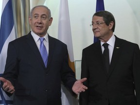 Cyprus' president Nikos Anastasiades, left, talks with Israeli Prime Minister Benjamin Netanyahu, at the presidential palace following a meeting with Greek Prime Minister Alexis Tsipras, in capital Nicosia, Cyprus, on Tuesday, May 8, 2018. Cyprus is hosting the Israeli Prime Minister and Greek Prime Minister in another trilateral meeting between the three leaders aimed at forging closer relations and cooperation on fields including energy, security, the environment, business and tourism.