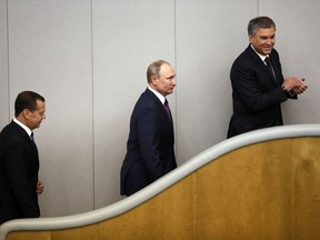 Russian President Vladimir Putin, centre, acting Prime Minister Dmitry Medvedev, left, and Russian State Duma speaker Vyacheslav Volodin attend a meeting of the State Duma, Russian parliament's lower house, in Moscow, Russia, Tuesday, May 8, 2018. The State Duma, lower parliament chamber is scheduled to vote for Dmitry Medvedev as new Premier.