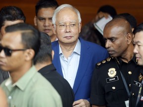 Former Malaysian Prime Minister Najib Razak, center, arrives at Anti-Corruption Agency for questioning in Putrajaya, Malaysia, Tuesday, May 22, 2018. He was summoned to meet with investigators nearly two weeks after the defeat of his long-ruling coalition in national elections.