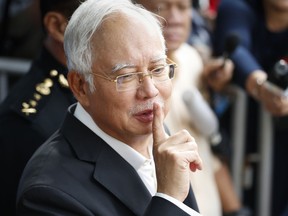Former Malaysian Prime Minister Najib Razak gestures as he leaves the Malaysian Anti-Corruption Commission (MACC) Office in Putrajaya, Malaysia, Thursday, May 24, 2018. Najib appeared again for questioning at the office as part of the corruption and money-laundering investigation into the 1MDB state investment fund that Najib set up and is being investigated.
