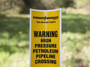 A sign where buried pipelines are located is seen in Burnaby B.C., just outside the Kinder Morgan location Thursday, April 26, 2018.