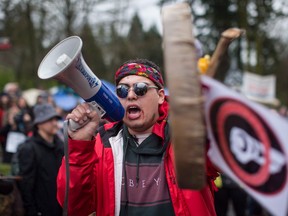 Cedar George-Parker addresses the crowd as protesters opposed to the Kinder Morgan Trans Mountain pipeline extension defy a court order and block an entrance to the company's property, in Burnaby, B.C., on Saturday April 7, 2018.