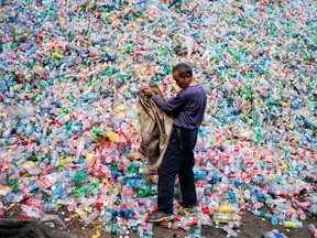 A Chinese labourer sorting out plastic bottles for recycling in Dong Xiao Kou village, on the outskirt of Beijing.