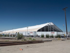 Truck trailers sit parked outside a newly constructed production tent to hide the goings-on at the Tesla Inc. manufacturing facility in Fremont, Calif.