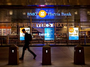 A pedestrian walks past a BMO Harris Bank NA branch on the ground floor of the company's headquarters in Chicago, Illinois, U.S., on Monday, June 11, 2018.