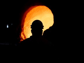 Senior melt operator Randy Feltmeyer examines a giant ladle after dumping its contents of red-hot iron used in the production of steel at the U.S. Steel Granite City Works facility, Thursday, June 28, 2018, in Granite City, Ill.