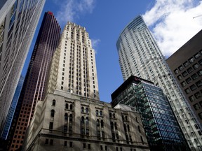 The Bank of Nova Scotia building, left, stands in Toronto, Ontario, Canada, on Friday, May 19, 2017. Ontario is easing rules for its pension funds as years of low interest rates, poor equity returns and a looming retiree glut pressure companies. Photographer: Brent Lewin/Bloomberg ORG XMIT: 700055667