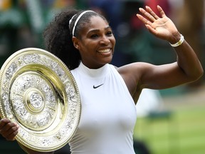 Serena Williams poses with the winner's trophy at the 2016 Wimbledon Championships