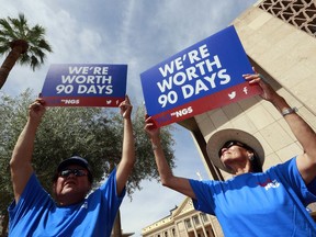 Roger Parrish and Diane Johnson, right, rally outside the Capitol in Phoenix, Wednesday, June 6, 2018. Hundreds of Navajo Generating Station employees, relatives and union and tribal leaders rallied at the state Capitol in Phoenix on Wednesday to request a 90-day pause in steps to close the coal-fueled plant by the end of 2019 as scheduled.