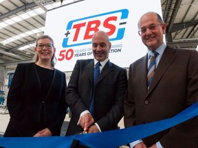 Tom Valvo, MiTek Industries Chief Operating Officer cuts the ribbon at the opening ceremony of TBS Engineering's new £15m HQ in the UK. From left to right: Viv Empson, TBS Group Finance and HR Director; Tom Valvo, MiTek Industries COO; and David Longney, TBS Group Managing Director.
