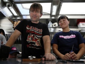 In this Friday, June 8, 2018, photo Gerald Abraham and Chizuru Abraham, who started their Japanese food truck in Los Angeles three years ago, pose for photo inside one of their Okamoto Kitchen trucks in Beverly Hills, Calif. Okamoto Kitchen has been successful, and added a second truck a year ago, because the couple has chosen their menu carefully. Rather than sushi and tempura, they serve meat, fish and sandwiches using traditional Japanese flavors like ponzu.