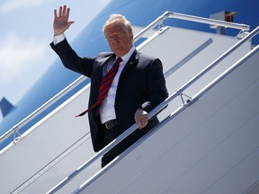 President Donald Trump steps off Air Force One as he arrives for the G7 Summit, Friday, June 8, 2018, in Canadian Forces Base Bagotville, Canada.