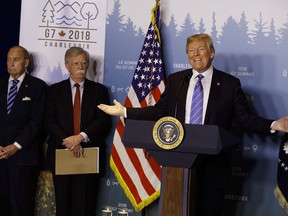 White House chief economic adviser Larry Kudlow, left, and National Security Adviser John Bolton look on as President Donald Trump speaks during a news conference at the G-7 summit, Saturday, June 9, 2018, in La Malbaie, Quebec, Canada.