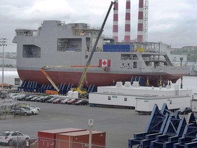 Two of the three mega-blocks of the future Canadian naval ship HMCS Harry DeWolf are seen at the Halifax Shipyard in Halifax on July 18, 2017. The union at the Halifax shipyard building some of the Royal Canadian Navy's new ships has given 48-hour strike notice. A news release issued late Wednesday by Unifor says hundreds of employees of the Halifax Shipyard have rejected a tentative contract.