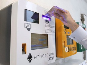 A man uses the Ethereum ATM, beside a Bitcoin ATM, in Hong Kong on May 11, 2018.