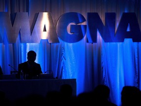 A Magna International Inc., sign is silhouetted at the company's annual general meeting in Toronto on May 10, 2013.