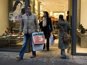 Shoppers exit an Aldo shoe store in New York, Sunday, Dec. 23, 2007. Montreal-based Aldo Group Inc. has agreed to pay US$120,000 under a settlement regarding allegations the shoe retailer used job applications that asked applicants about their criminal history, according to the New York state attorney general.