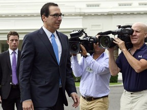 Treasury Secretary Steven Mnuchin walks out to speak with reporters at the White House in Washington, Wednesday, June 27, 2018.