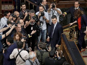 Socialist leader Pedro Sanchez is surrounded by photographers  in the parliament after a motion of no confidence vote at the Spanish parliament in Madrid, Friday, June 1, 2018. Opposition Socialist leader Pedro Sanchez has won the vote to replace Mariano Rajoy as prime minister, in the first ouster of a serving Spanish leader by parliament in four decades of democracy.