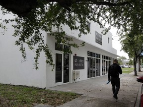 In this Monday, May 21, 2018 photo, a man walks past the former Clyde Killens pool hall in the Overtown neighborhood of Miami. The building has been purchased by celebrity chef Marcus Samuelsson, who plans to open a restaurant at the location. The redevelopment board is pouring tens of millions into restoring the historic neighborhood to its former glory.