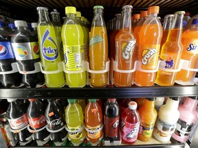 FILE - This Sept. 21, 2016 file photo shows soft drink and soda bottles displayed in a refrigerator at El Ahorro market in San Francisco. The California Legislature is expected to vote to prohibit local governments from creating new taxes on soda on Thursday, June 28, 2018. In exchange, the beverage industry has agreed to drop a ballot measure that would have made it much harder for cities and counties to raise taxes.