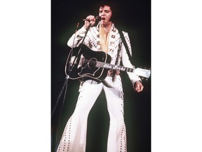 FILE - In this 1973 file photo, Elvis Presley sings during a concert. A private jet once owned by Elvis Presley that has sat on a runway in New Mexico for nearly four decades is back on the auction block. The online auction site IronPlanet announced this week that plane with red velvet seats had returned the market after its current owner bought it last year for $430,000.