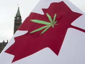FILE - In this April 20, 2015 file photo, a Canadian flag with a cannabis leaf flies on Parliament Hill during a 4/20 protest in Ottawa, Ontario. Canada is following the lead of Uruguay in allowing a nationwide, legal marijuana market, although each Canadian province is working up its own rules for pot sales. The federal government and the provinces also still need to publish regulations that will govern the cannabis trade.