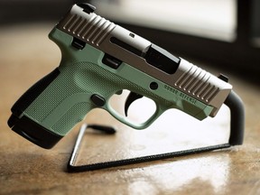 In this April 25, 2018 photo, a .9mm handgun produced by Honor Defense, a gunmaker in Gainesville, Ga., is displayed. In the wake of high-profile mass shootings, corporate America has been taking a stand against the firearms industry amid a lack of action by lawmakers on gun control. Payment processing firms are limiting transactions, Bank of America stopped providing financing to companies that make AR-style guns, and retailers like Walmart and Dick's Sporting Goods imposed age restrictions on gun purchases.