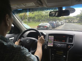 Uber driver Joshua Oh drives in Honolulu on Wednesday, June 6, 2018. Honolulu's city council is scheduled to vote on a bill that won't allow ride-hailing services to impose so-called "surge pricing" on riders if the fee is higher than a maximum amount set by the city. The bill says the city would set a maximum fare private transportation companies may charge. That would prevent surge prices that are higher than the city-set limit.