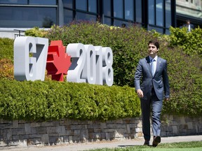 Canada's Prime Minister Justin Trudeau arrives for a welcoming ceremony for representatives from outreach countries and international organizations during the G7 leaders summit in La Malbaie, Que., on Saturday, June 9, 2018.