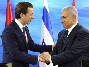 Austrian Chancellor Sebastian Kurz, left, shakes hands with Israeli Prime Minister Benjamin Netanyahu, during a meeting at the prime minister's office in Jerusalem, Monday, June 11, 2018.