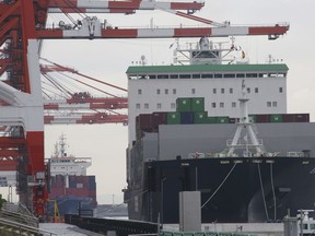 A container ship, right, arrives at a container terminal in Tokyo, Monday, June 18, 2018. Japan's exports to the U.S. grew 5.8 percent in May from a year ago as shipments of machinery and vehicles rose, according to government data released Monday.
