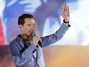FILE- In this Monday, April 16, 2018 file photo, Benedict Cumberbatch waves to fans during Marvel's Avengers: Infinity War red carpet fan event in Singapore. Food-delivery firm Deliveroo has thanked Benedict Cumberbatch after the "Sherlock" star reportedly fought off muggers who were attacking a cyclist working for the company. Uber driver Manuel Dias told the Sun newspaper that he was driving Cumberbatch and his wife Sophie Hunter along London's Marylebone High Street when they saw a cyclist being hit with a bottle.