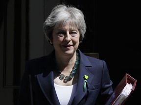 Britain's Prime Minister Theresa May leaves 10 Downing Street to attend the weekly session of PMQs at parliament in London, Wednesday, June 13, 2018.