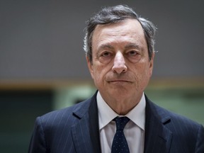 FILE - In this Thursday, May 24, 2018 file photo, President of the European Central Bank Mario Draghi arrives for an eurogroup meeting at the Europa building in Brussels. The European Central Bank said Thursday, June 14 it will phase out at year-end the bond-buying stimulus program credited with helping the 19 countries that use the euro recover from the Great Recession and eurozone debt crisis. The bank's move toward the exit comes a day after the U.S. Federal Reserve decide to make its second interest rate increase this year and indicated more were coming. ECB President Mario Draghi says the bank's policy of easy money has helped create millions of new jobs, with unemployment falling from over 12 percent during the crisis to 8.5 percent.