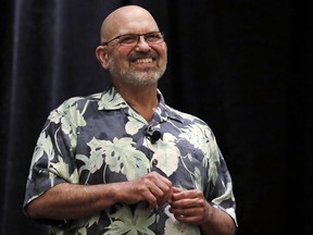 In this Thursday, May 24, 2018, photo, Boston Dynamics founder and CEO Marc Raibert smiles as he responds to a question during a robotics summit in Boston. It's never been clear whether robotics company Boston Dynamics is making killing machines, household helpers, or something else entirely. For nine years, the secretive firm, which got its start with U.S. military funding, has unnerved people around the world with YouTube videos of experimental robots resembling animal predators.