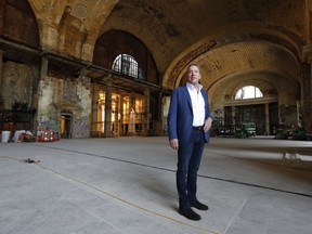 In this Thursday, June 14, 2018 photo, Bill Ford Jr., Ford Motor Company Executive Chairman and Chairman of the Board, poses in the Michigan Central Station in Detroit. Ford Motor Co. is embarking on a 4-year renovation of the 105-year-old depot and 17-story office tower just west of downtown. The massive project is expected to increase the automaker's footprint in the city where the company was founded, provide space for electric and autonomous vehicle testing and research and spur investment in the surrounding neighborhood.