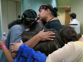 Line 3 pipeline opponents, in tears, console each other in the hallway of the Public Utilities Commission Thursday, June 28, 2018 while the commission goes on break, after three of the five commissioners indicated they might vote in favor of allowing the Line 3 pipeline replacement project to move forward. The Minnesota Public Utilities Commission began its deliberations on Enbridge Energy's proposed Line 3 pipeline replacement project Thursday at its headquarters in downtown St. Paul, ten days after beginning its final round of hearings and question sessions in the case.