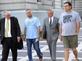 FILE - In this undated file photo, David Nicoll, center left, 39, of Mountain Lakes, N.J., president of Biodiagnostic laboratory Services, and employee and brother Scott Nicoll, right, 32, of Wayne, N.J., leave Federal Court in Newark, N.J., with representatives after being arrested in 2013 and pleaded guilty to conspiracy and money laundering through their New Jersey company. The brothers are scheduled to appear before a federal judge in Newark, facing sentencing on Wednesday, June 13, 2018.